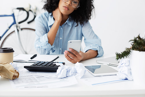 woman with calculator frustrated student loan